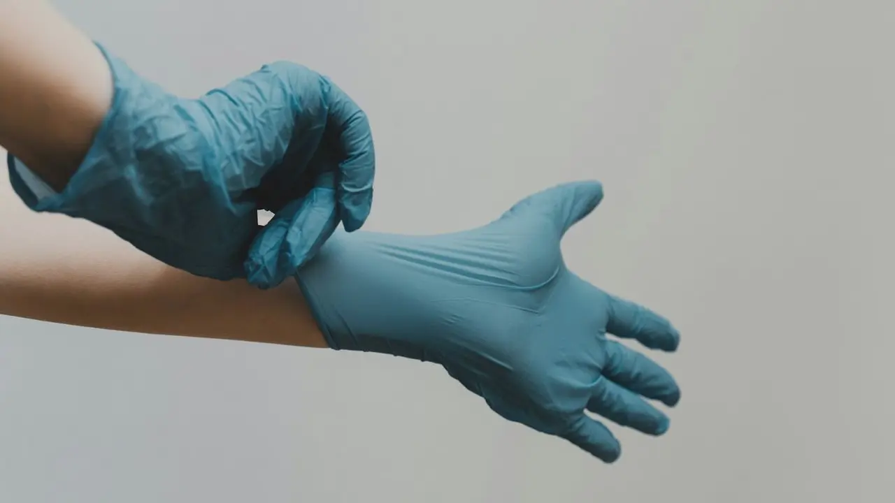 person in blue gloves and blue denim jeans